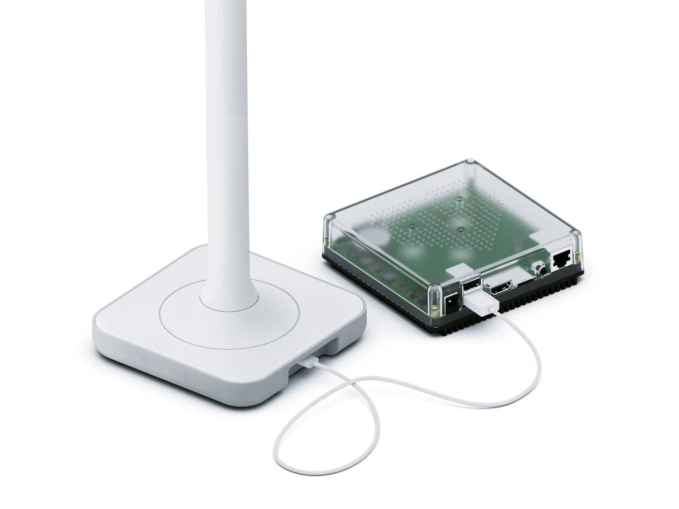 The Home Assistant Connect ZWA-2 Z-Wave USB adapter plugged into the USB-C port of a Home Assistant Green mini server.