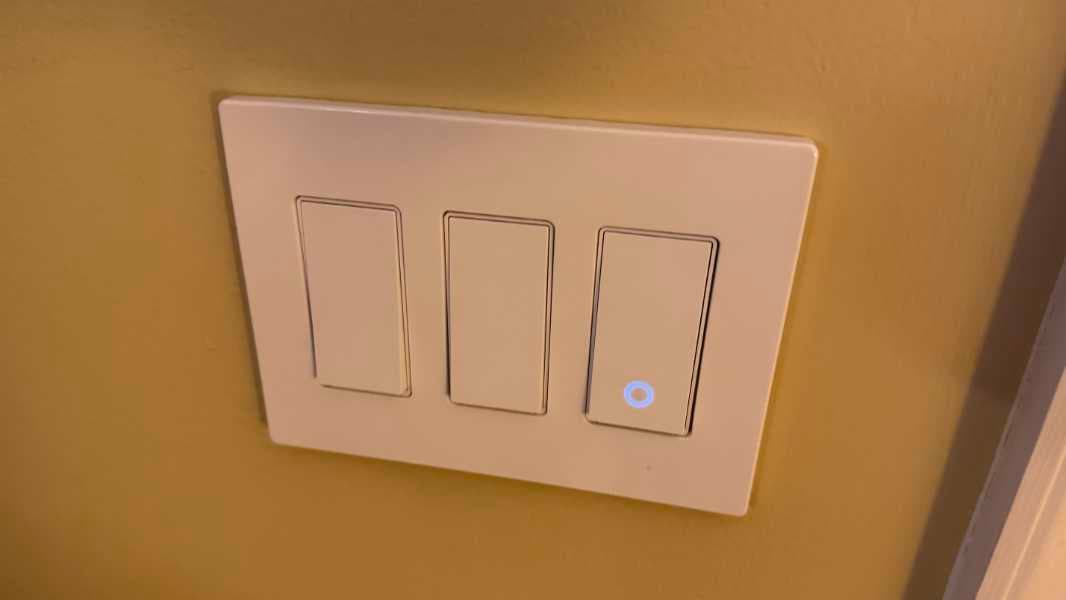Modern smart light switches on a wall in a warm contemporary home interior