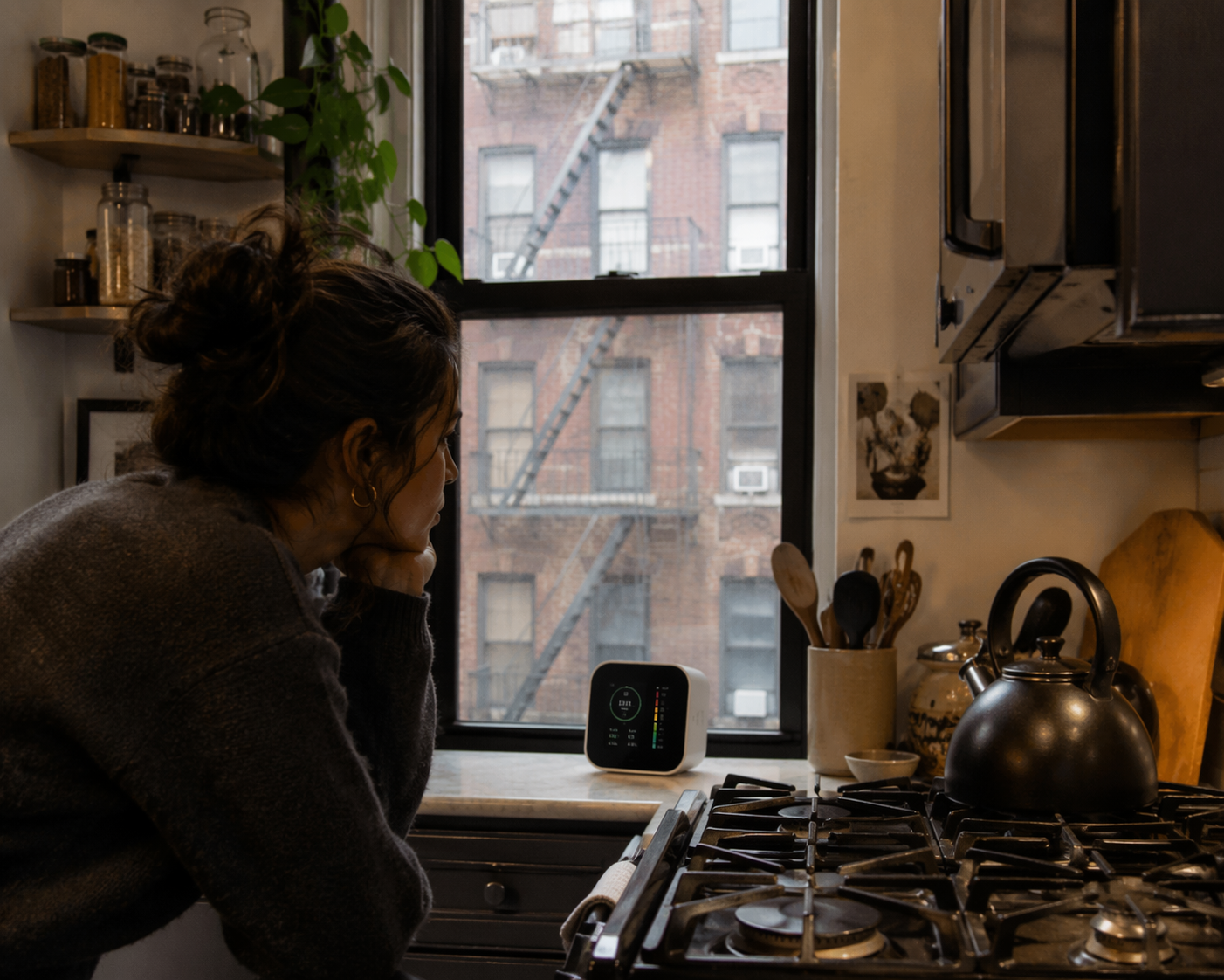 Air quality monitor on a compact NYC apartment kitchen counter near a gas stove