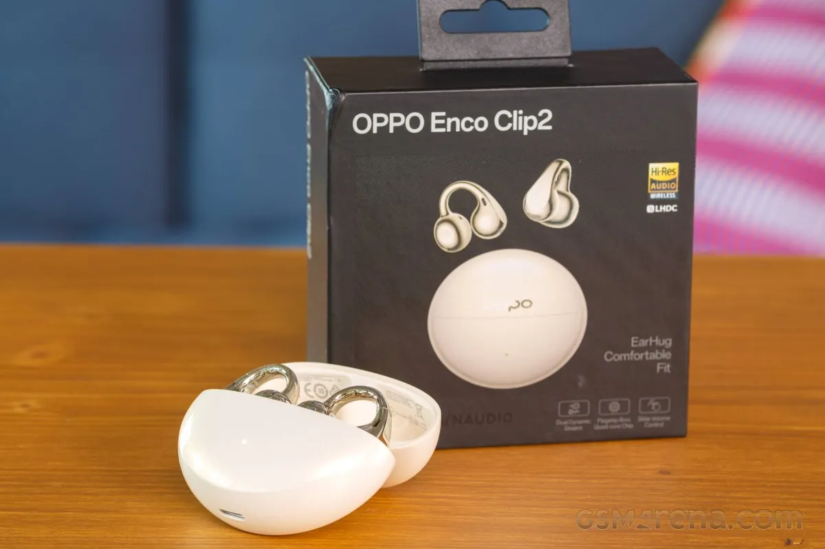Hands-on photo of the OPPO Enco Clip2 open-ear earbuds and charging case