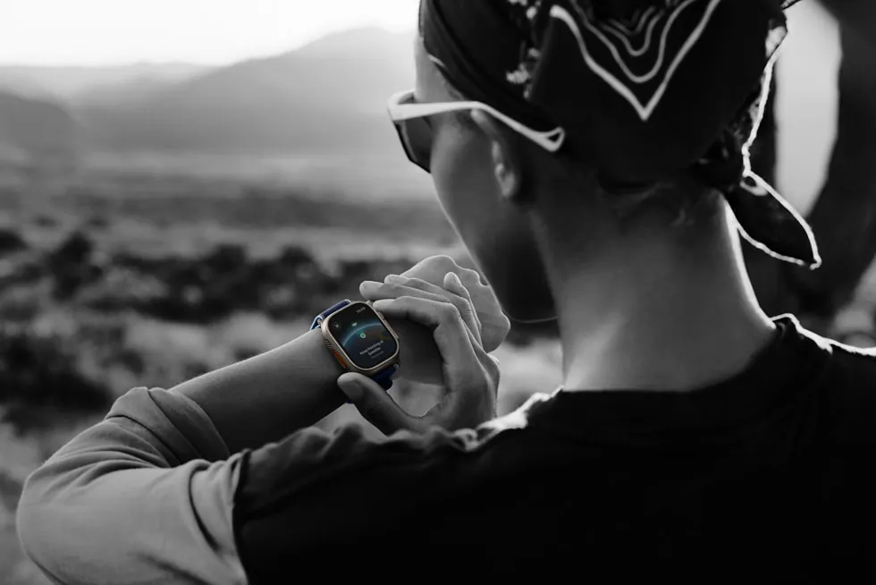 Person wearing Apple Watch Ultra 3 while hiking outdoors