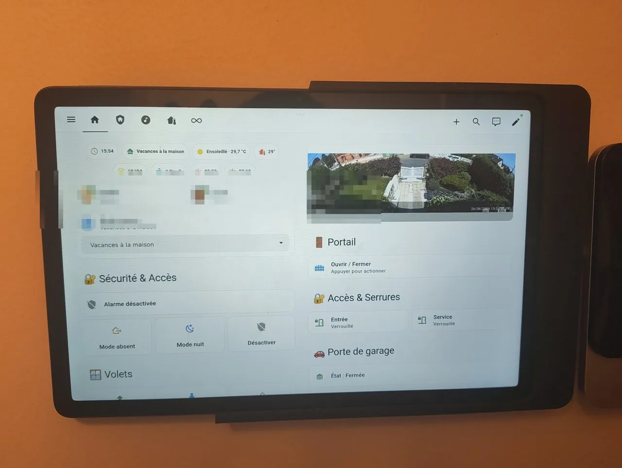 A wall-mounted Redmi Pad SE 11 showing a smart-home dashboard