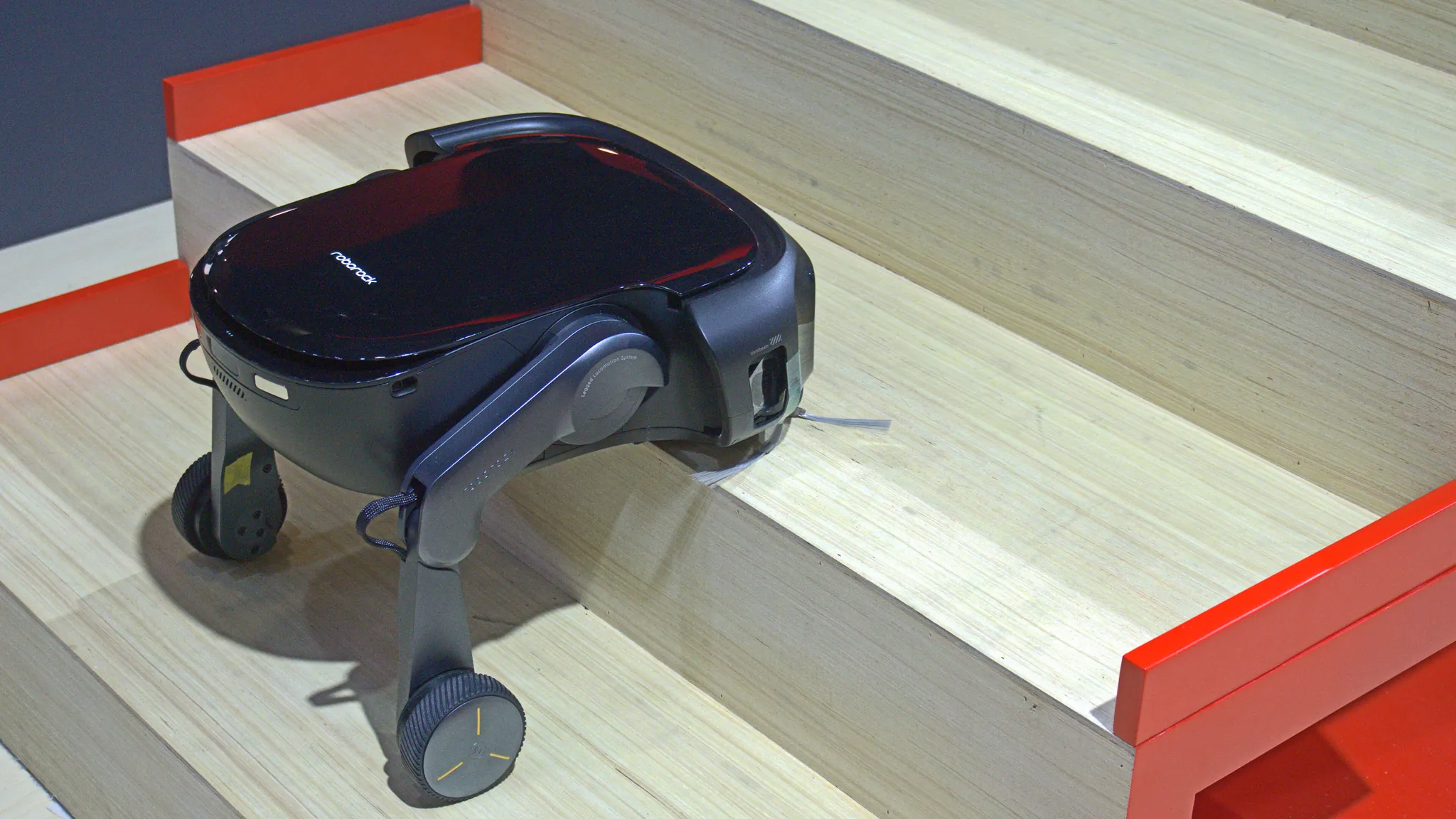 Roborock Saros Rover robot vacuum with articulated wheel-leg mechanism at CES 2026