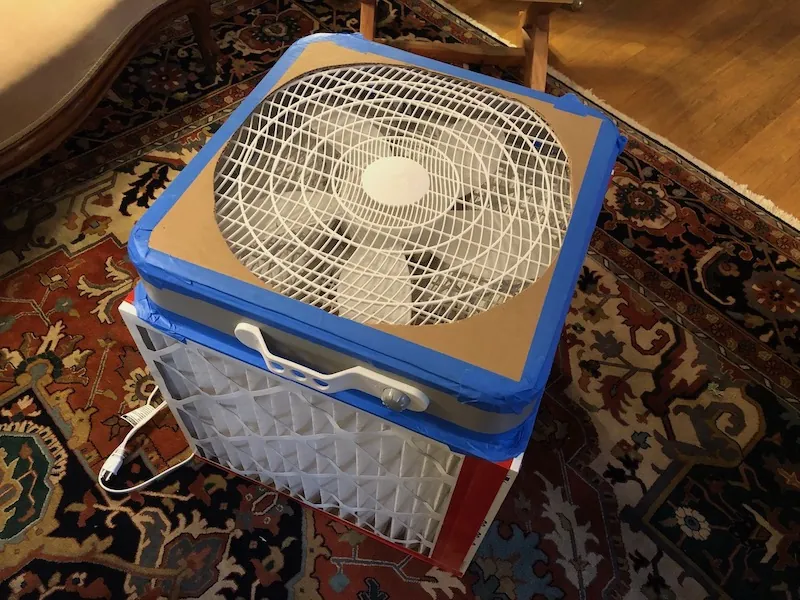DIY Corsi-Rosenthal box-fan air cleaner with a pleated filter and shroud